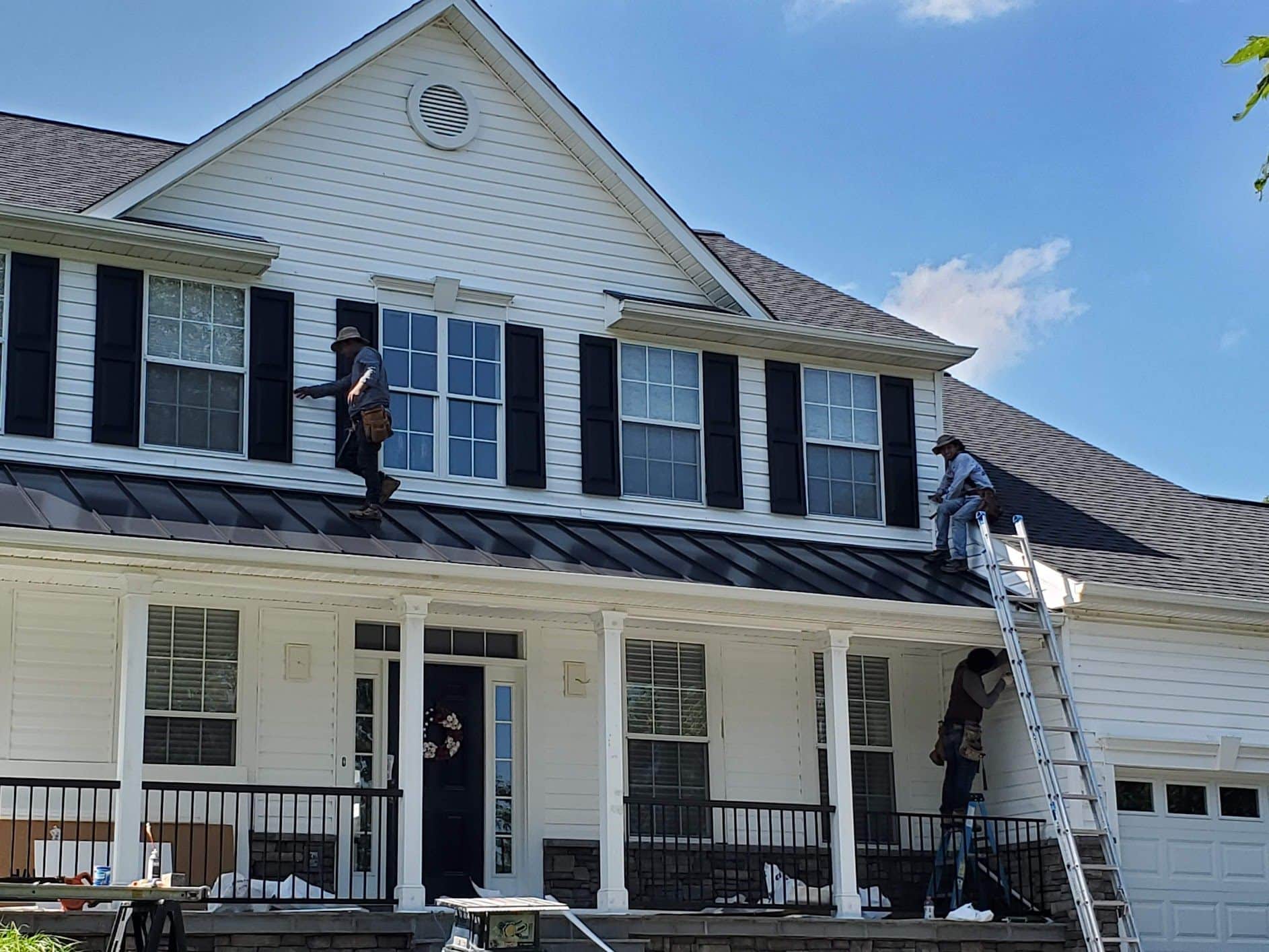 Apper Construction's Maryland crew installing replacement windows and asphalt shingle roofing on a two-story colonial in Anne Arundel County